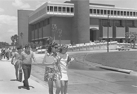 Library, c. early 1970s - Students walking on sidewalk