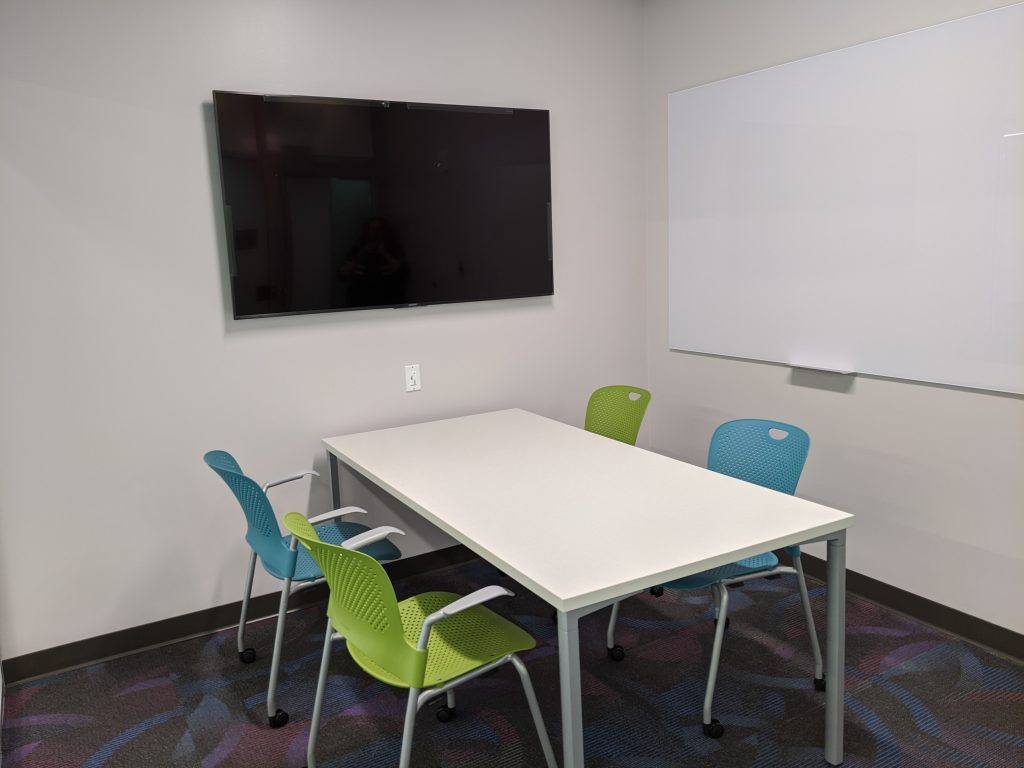 1st Floor Study Room with 4 chairs, 1 whiteboard, and 1 monitor