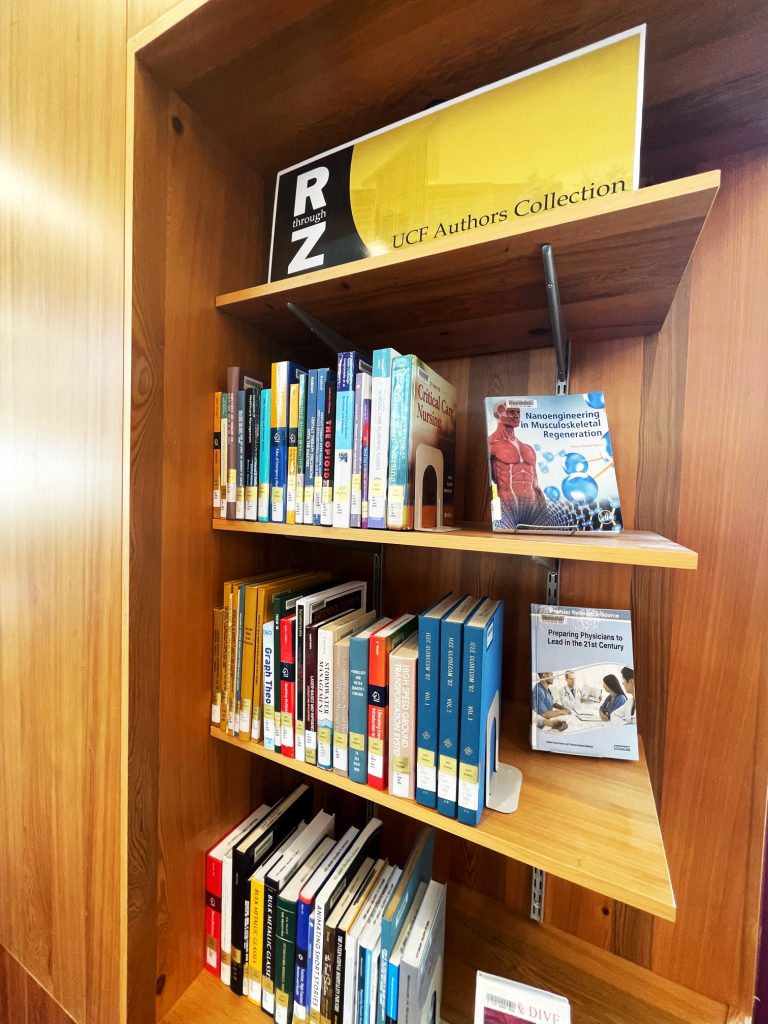 Photo of several books on a wooden bookcase.