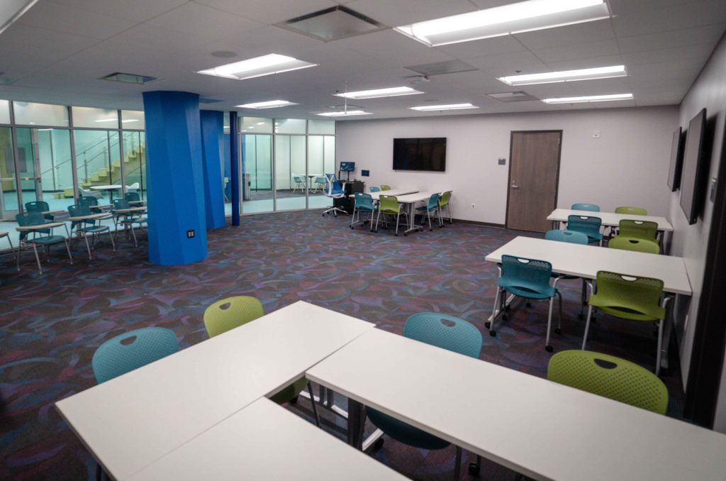Classroom 170 - open concept with student workstations along the walls with mounted monitors and movable individual seats