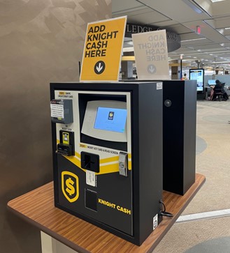 Knightcash machine on a table on the 2nd Floor of the library near the Print Zone.