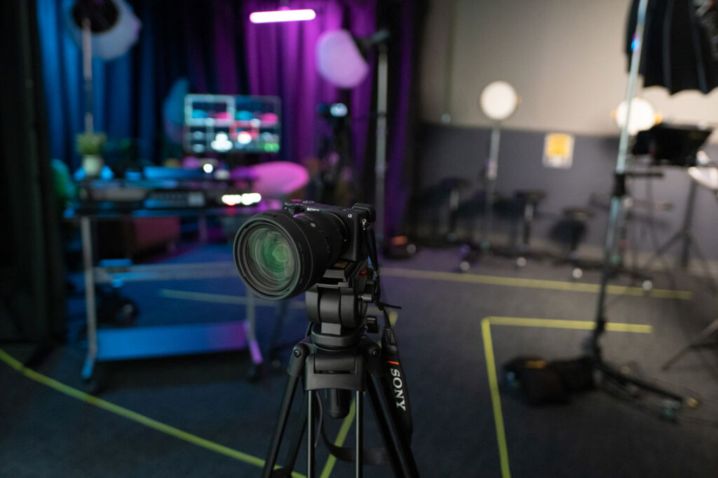 John C. Hitt Library Production Studio with cameras, recording equipment, and colored lighting.