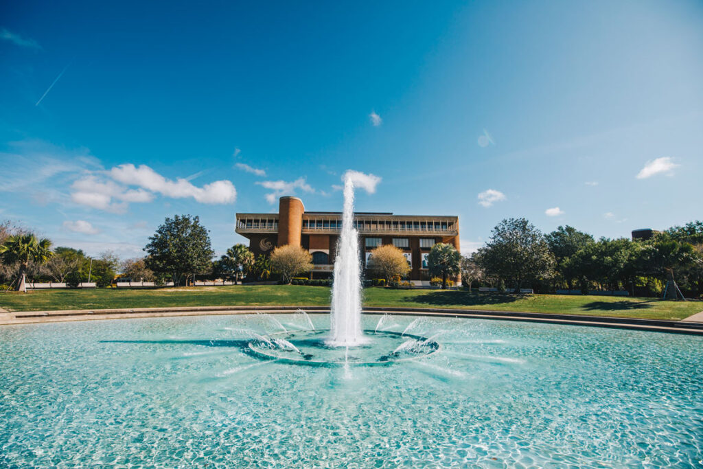 UCF Library legacy entrance in the background with the Reflecting Pond fountain centered in the foreground.