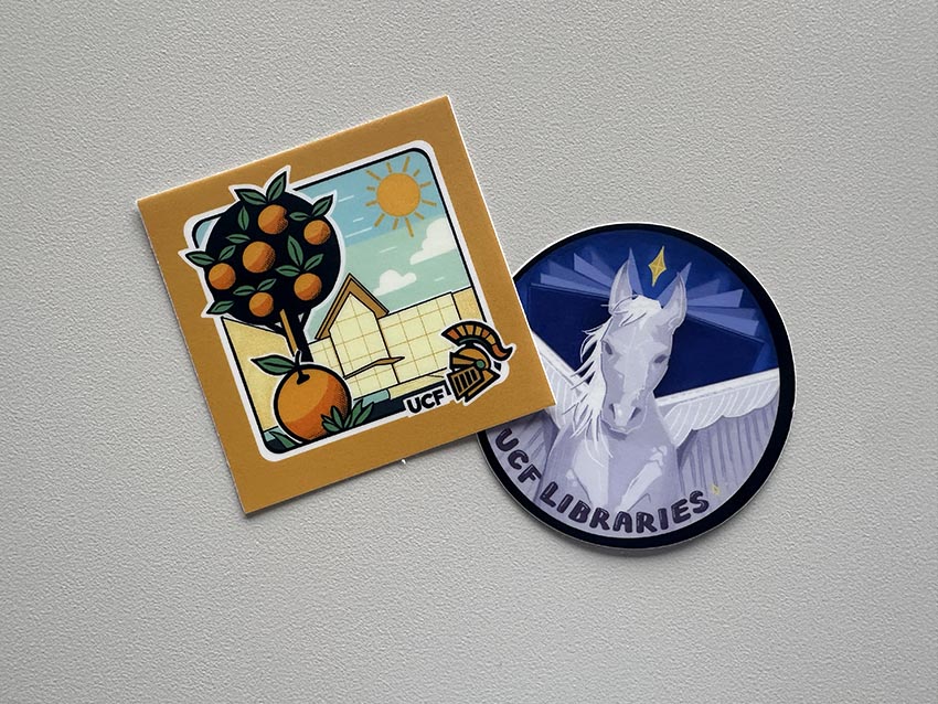 Two stickers on a white background. One has an orange tree and a library in the background, and the other has a pegasus with a star above it's head.
