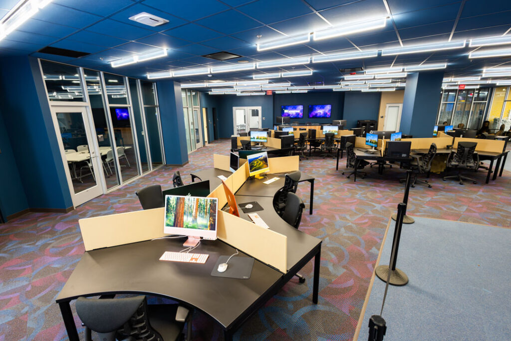 Open seating room with desks and computer work stations.