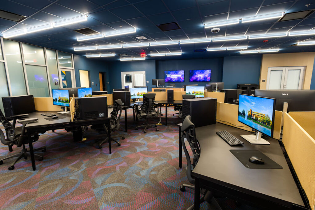 Open seating room with desks and computer work stations.